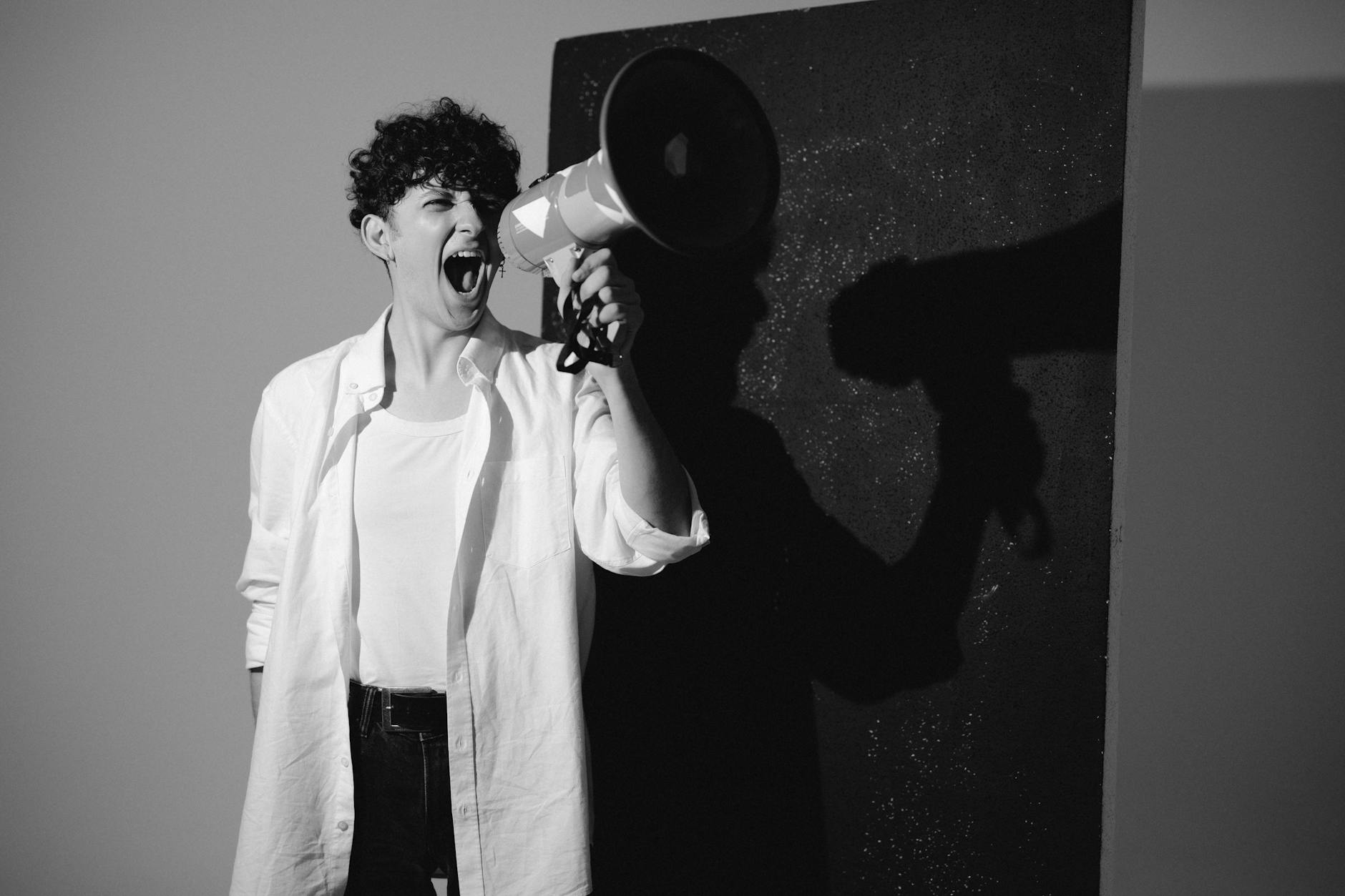 man holding a megaphone shouting